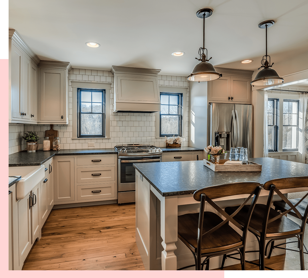Modern kitchen with island and wooden floor.